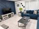 Modern living room boasts a blue accent wall, contemporary furniture, and plenty of natural light at 3593 Adkins Nw Rd, Atlanta, GA 30331