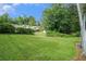 Grassy backyard space with mature trees and storage shed in background at 3650 Croft Nw Pl, Atlanta, GA 30331