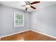 Bedroom with hardwood floors, neutral paint, a ceiling fan, and bright window at 3650 Croft Nw Pl, Atlanta, GA 30331