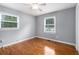 Bright bedroom features gleaming hardwood floors, two windows, and neutral color scheme at 3650 Croft Nw Pl, Atlanta, GA 30331