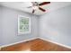 Bedroom featuring gleaming hardwood floors, a window, and a ceiling fan at 3650 Croft Nw Pl, Atlanta, GA 30331