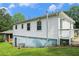 Exterior view of home with white siding, blue foundation, and rear access door at 3650 Croft Nw Pl, Atlanta, GA 30331