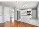 Bright, modern kitchen with stainless steel appliances, white cabinetry, and a view into the living area at 3650 Croft Nw Pl, Atlanta, GA 30331