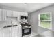 Well-equipped kitchen featuring stainless steel appliances, white cabinets, and a subway tile backsplash at 3650 Croft Nw Pl, Atlanta, GA 30331