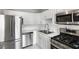 Modern kitchen with stainless steel appliances, white cabinets, subway tile, and ample counter space at 3650 Croft Nw Pl, Atlanta, GA 30331