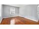 The bright living room has hardwood floors, light-gray walls and a window, making it a comfortable place to relax at 3650 Croft Nw Pl, Atlanta, GA 30331
