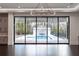 An expansive backyard with a swimming pool and outdoor kitchen are visible through sliding glass doors at 5211 Powers Ferry Rd, Sandy Springs, GA 30327
