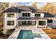 Elegant home exterior with a beautiful pool, spa, and patio area ideal for relaxing and entertaining guests at 5211 Powers Ferry Rd, Sandy Springs, GA 30327