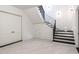 A spacious basement with tile flooring, access to the staircase, a closet, and a storage room at 5211 Powers Ferry Rd, Sandy Springs, GA 30327