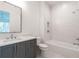 Well-lit bathroom with a gray vanity, tiled shower, and soaking tub at 5211 Powers Ferry Rd, Sandy Springs, GA 30327