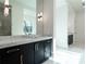 Bathroom featuring double sink vanity and marble tile with shower view at 5211 Powers Ferry Rd, Sandy Springs, GA 30327