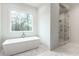 Bathroom featuring soaking tub, walk-in shower, and natural light at 5211 Powers Ferry Rd, Sandy Springs, GA 30327