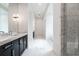 Bright bathroom with marble floors and dark cabinets, plus a glass shower at 5211 Powers Ferry Rd, Sandy Springs, GA 30327