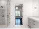 Bright bathroom featuring a glass-enclosed shower and a view into the next room at 5211 Powers Ferry Rd, Sandy Springs, GA 30327