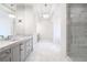 Spacious bathroom featuring double sinks, a walk-in shower, and elegant lighting fixtures at 5211 Powers Ferry Rd, Sandy Springs, GA 30327