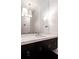 Elegant bathroom with a spacious vanity, quartz countertop, and stylish light fixtures above the mirrors at 5211 Powers Ferry Rd, Sandy Springs, GA 30327