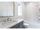 This bathroom offers a large vanity, chrome fixtures, shower-tub combination and white subway tile at 5211 Powers Ferry Rd, Sandy Springs, GA 30327