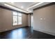 Bedroom with tray ceilings, natural light, and dark hardwood floors at 5211 Powers Ferry Rd, Sandy Springs, GA 30327