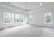 Spacious bedroom with neutral carpet, large windows, and a ceiling fan at 5211 Powers Ferry Rd, Sandy Springs, GA 30327