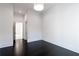 A naturally lit bedroom with black stained hardwood floors and white molding along the baseboards at 5211 Powers Ferry Rd, Sandy Springs, GA 30327