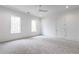 This bedroom features neutral walls, carpet, white trim, a ceiling fan and dual windows at 5211 Powers Ferry Rd, Sandy Springs, GA 30327