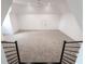 This bonus room features neutral walls, carpet, black iron railings and white trim at 5211 Powers Ferry Rd, Sandy Springs, GA 30327