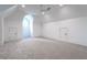 This bonus room features neutral walls, carpet, white trim and a round window at 5211 Powers Ferry Rd, Sandy Springs, GA 30327