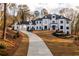 Elegant two-story home featuring a long driveway and manicured landscaping at 5211 Powers Ferry Rd, Sandy Springs, GA 30327