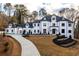 Elegant two-story home featuring a long driveway and manicured landscaping at 5211 Powers Ferry Rd, Sandy Springs, GA 30327