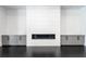 Living room showcases a modern fireplace with custom built-in cabinets and hardwood floors at 5211 Powers Ferry Rd, Sandy Springs, GA 30327