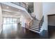 Bright foyer with staircase and railing, hardwood floors, and a view into the main living space at 5211 Powers Ferry Rd, Sandy Springs, GA 30327