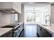 Modern kitchen with sleek stainless steel appliances and stone countertops at 5211 Powers Ferry Rd, Sandy Springs, GA 30327