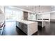 Spacious kitchen featuring double islands with white countertops and open design to the living area at 5211 Powers Ferry Rd, Sandy Springs, GA 30327