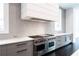 High-end kitchen with a state-of-the-art range, sleek vent hood, and stylish gray cabinetry at 5211 Powers Ferry Rd, Sandy Springs, GA 30327