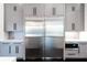 Well-organized kitchen with built-in stainless steel refrigerator and gray cabinets at 5211 Powers Ferry Rd, Sandy Springs, GA 30327