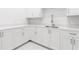 This kitchenette features all white cabinets, white countertops and stainless steel hardware at 5211 Powers Ferry Rd, Sandy Springs, GA 30327