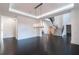 Spacious living room with hardwood floors, modern lighting fixture, and an open staircase at 5211 Powers Ferry Rd, Sandy Springs, GA 30327