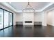 Bright living room showcases a modern fireplace, custom built-ins, hardwood floors and sliding glass doors at 5211 Powers Ferry Rd, Sandy Springs, GA 30327