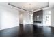 Spacious living room featuring a modern fireplace, dark wood floors, and a contemporary light fixture at 5211 Powers Ferry Rd, Sandy Springs, GA 30327