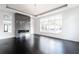 Bright living room features a modern fireplace, large windows and hardwood floors at 5211 Powers Ferry Rd, Sandy Springs, GA 30327
