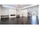 Spacious living room featuring a modern fireplace, custom built-ins, hardwood floors and staircase at 5211 Powers Ferry Rd, Sandy Springs, GA 30327