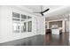 Open concept living area features large windows, ceiling fan, and kitchen with stainless steel appliances at 5211 Powers Ferry Rd, Sandy Springs, GA 30327