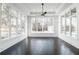 Bright living room featuring a wall of windows and dark hardwood floors at 5211 Powers Ferry Rd, Sandy Springs, GA 30327