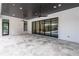 Covered patio with ceiling fans and expansive sliding doors overlooking the pool area at 5211 Powers Ferry Rd, Sandy Springs, GA 30327