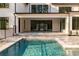 Luxurious pool area with an outdoor living space, patio and sleek design at 5211 Powers Ferry Rd, Sandy Springs, GA 30327
