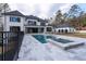 Beautiful backyard showcasing a sparkling pool, hot tub, and expansive patio area perfect for outdoor entertaining at 5211 Powers Ferry Rd, Sandy Springs, GA 30327