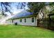 Backyard view of home with green lawn, vinyl siding and trees at 85 Chestnut Dr, Covington, GA 30016
