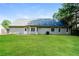 Backyard view of home with green lawn and vinyl siding at 85 Chestnut Dr, Covington, GA 30016