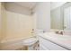 Bathroom featuring tile floors, a shower-tub combo, and a vanity with counter space at 85 Chestnut Dr, Covington, GA 30016