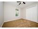 This bedroom features carpeted floors and a window for natural lighting at 85 Chestnut Dr, Covington, GA 30016